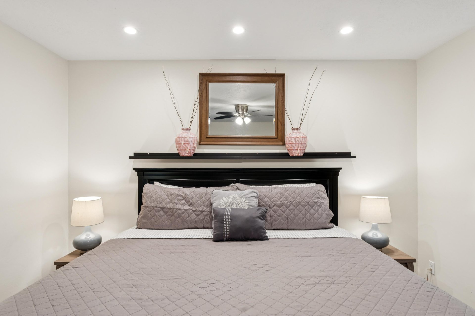 Freshly painted main bedroom with a great, sturdy bed frame and comfortable king mattress