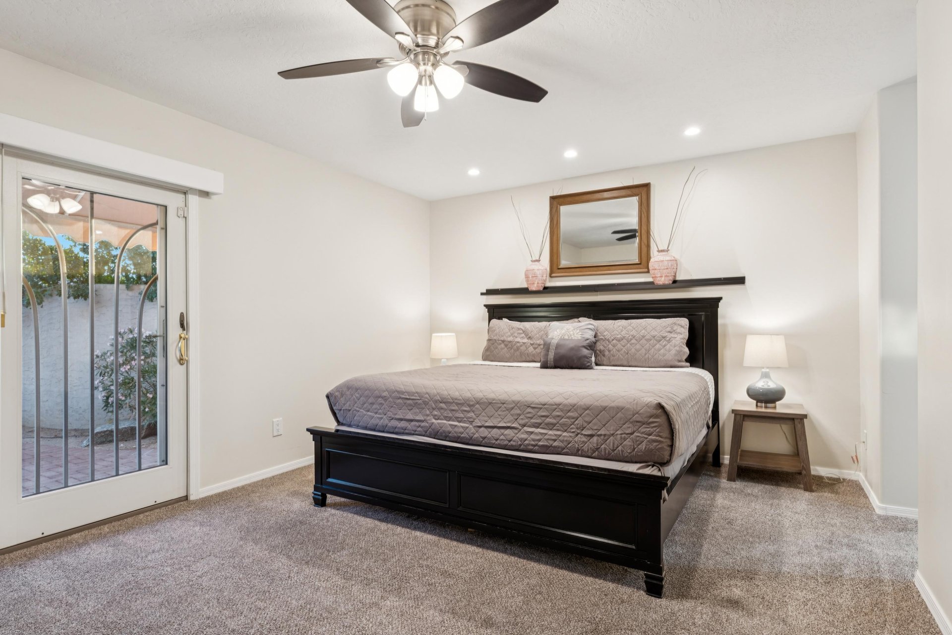 Oversized bedroom with a large flat screen tv and private patio access