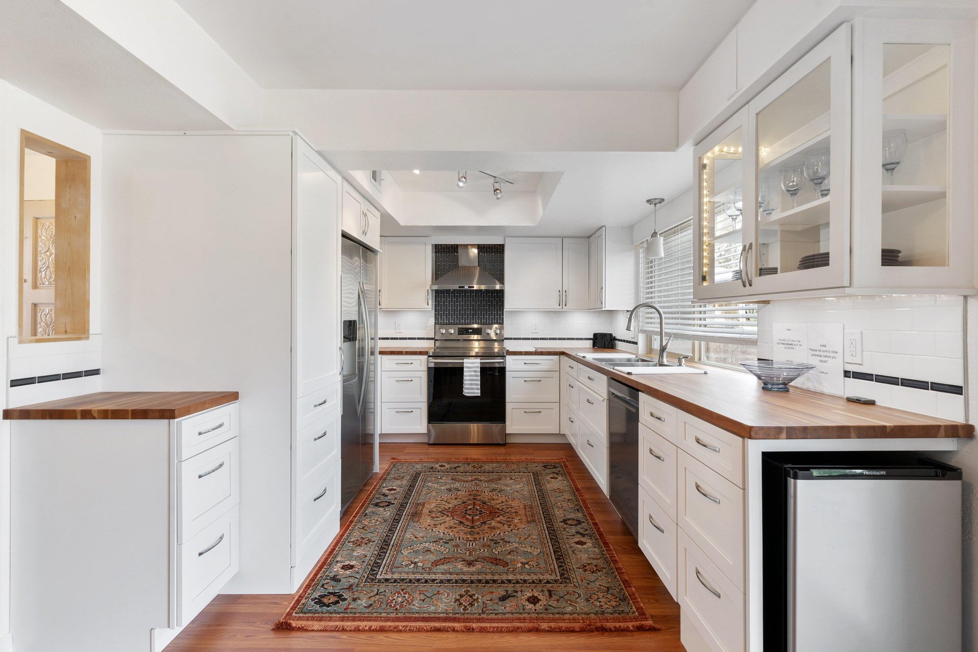 The long and spacious kitchen is a bright and beautiful place to create a meal together.
