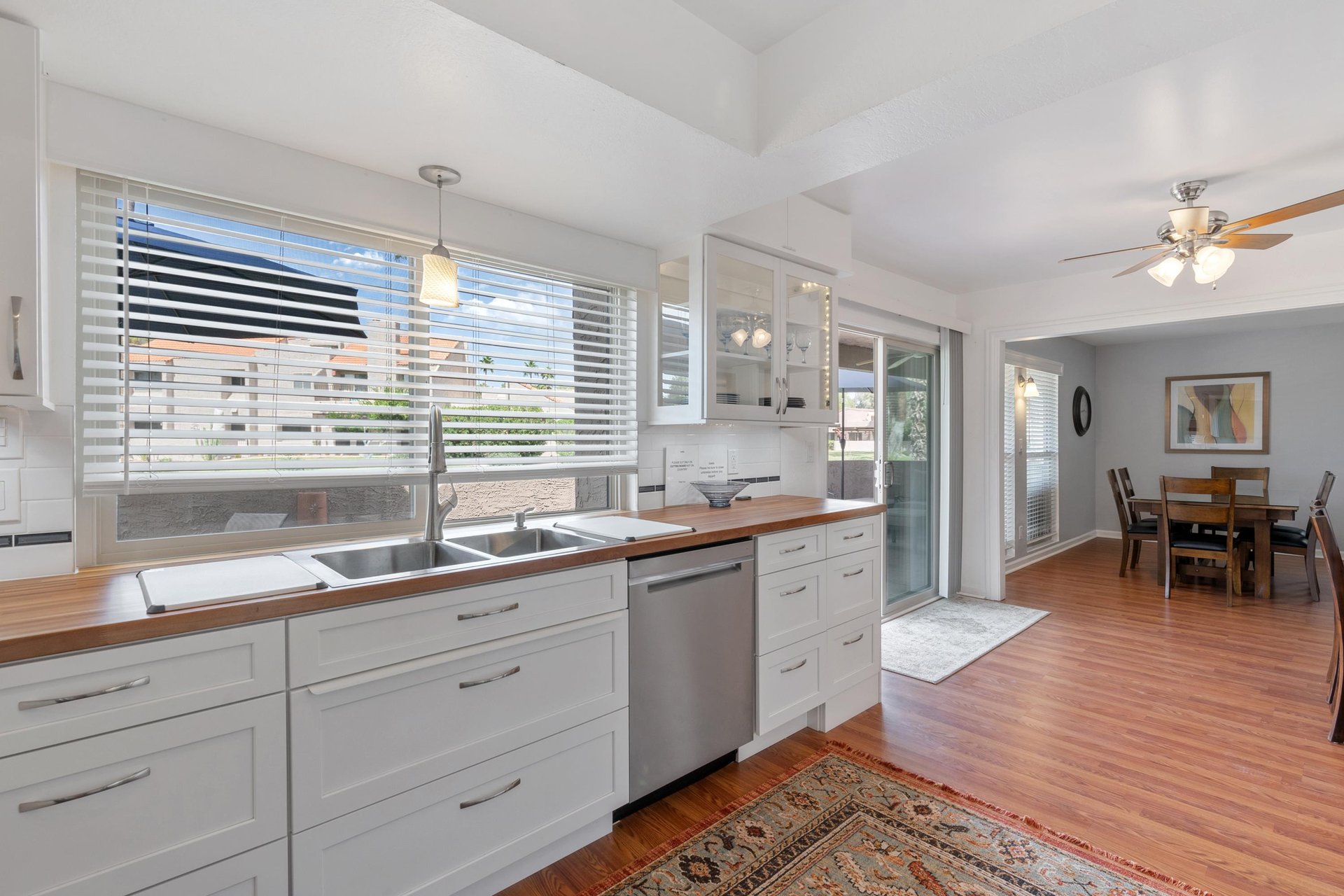 The sliding glass door between the kitchen and dining room leads to the sprawling and  spacious patio.