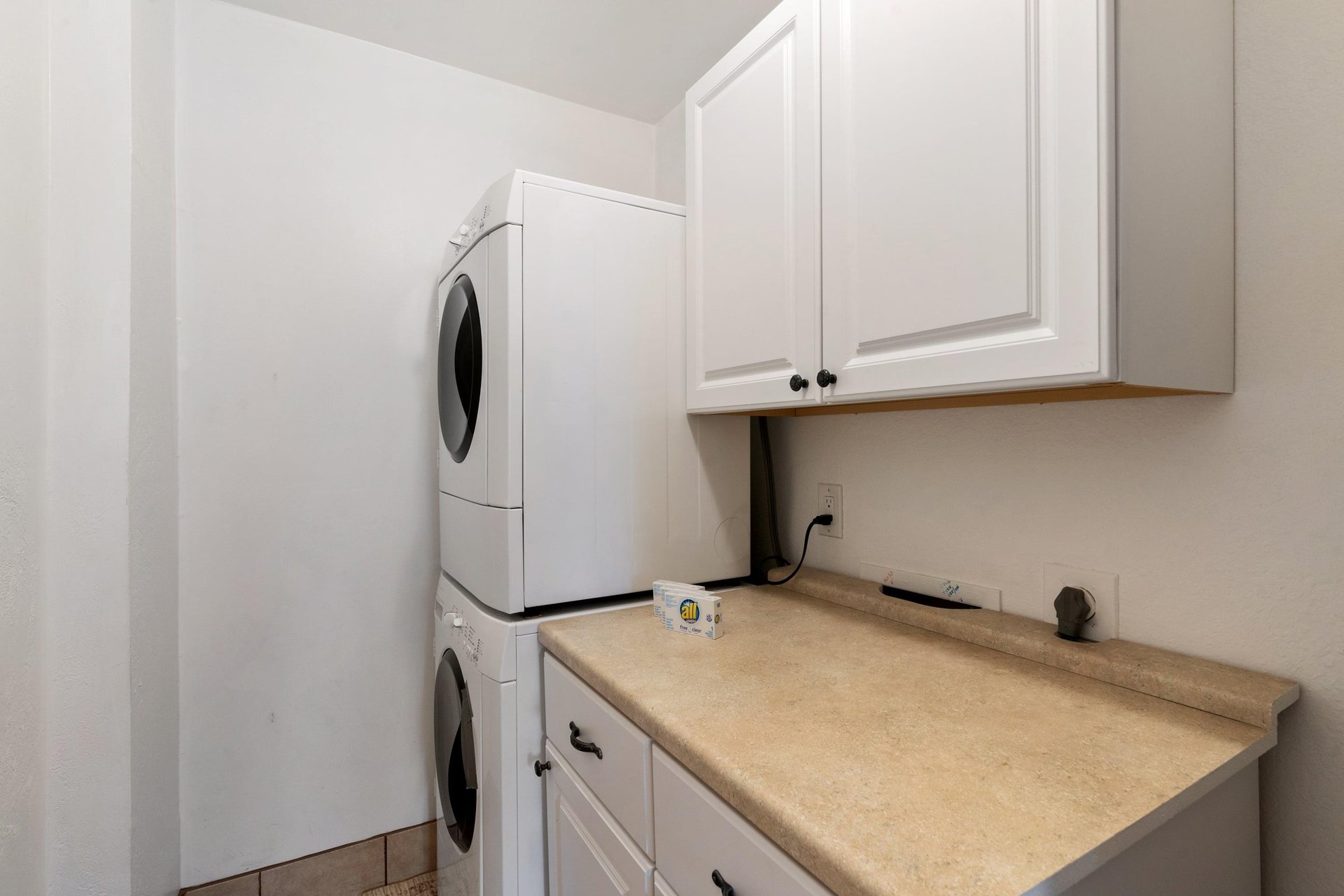 Laundry room is readily available for guest use with the stacked washer and dryer.