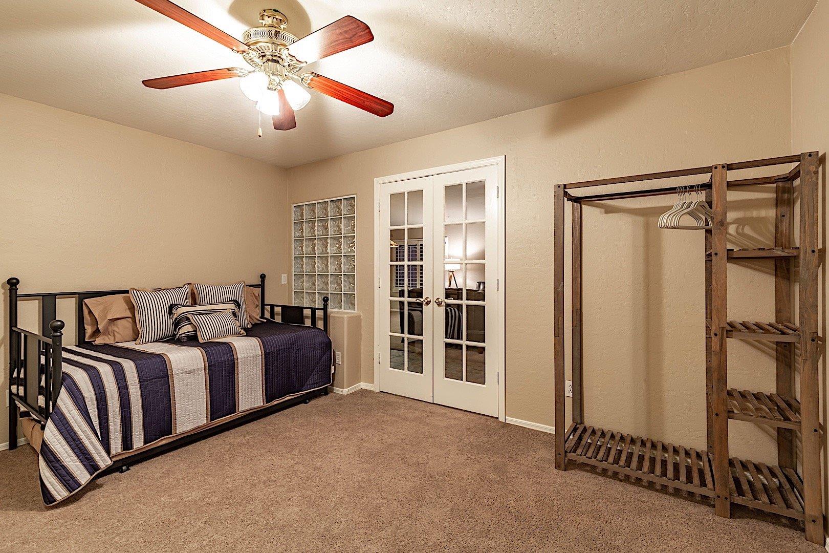 Office space with trundle bed and clothing storage