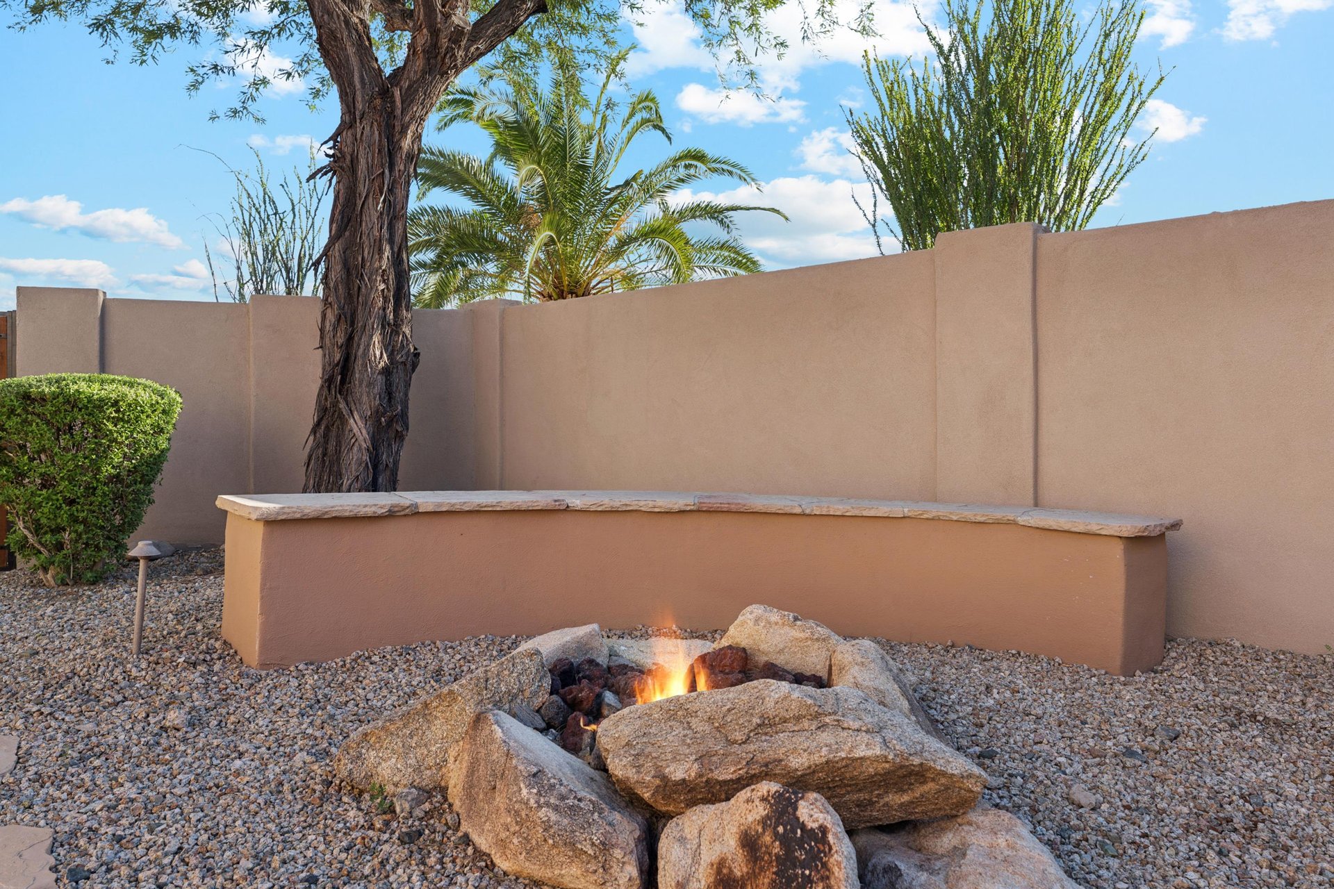 Gather around the gas firepit near the pool with the curved bench seating and breathtaking views