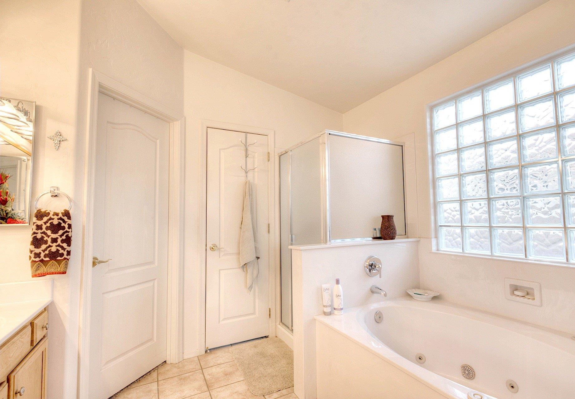 Bright and clean Master bath with Separate walk in shower and soaking tub