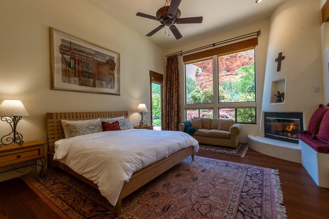 Master Bedroom With Access to Backyard and Fireplace