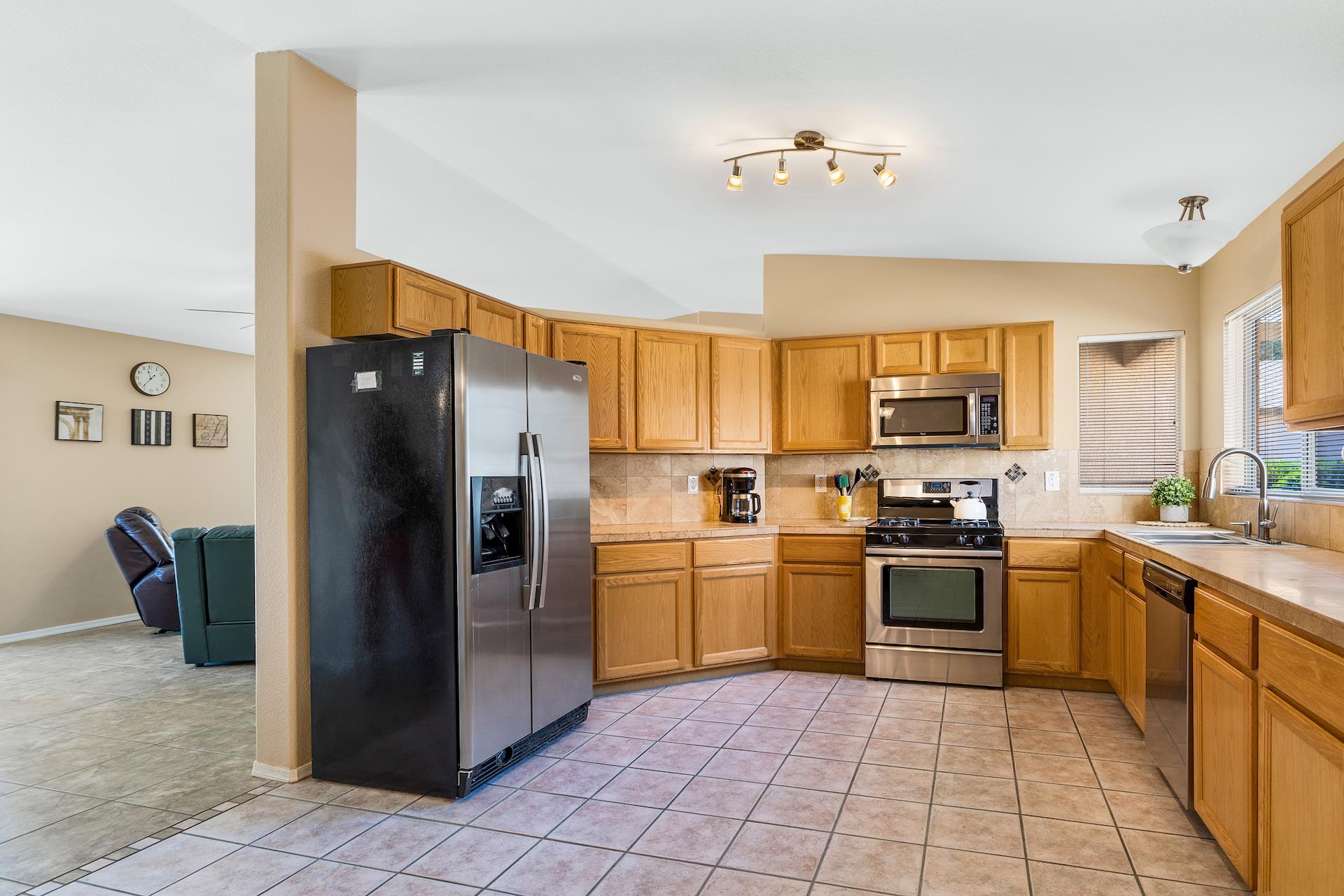 Open kitchen has great natural lighting and tile