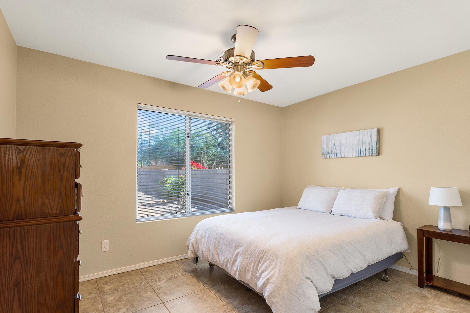 Third Bedroom, queen bed, has a view of the backyard