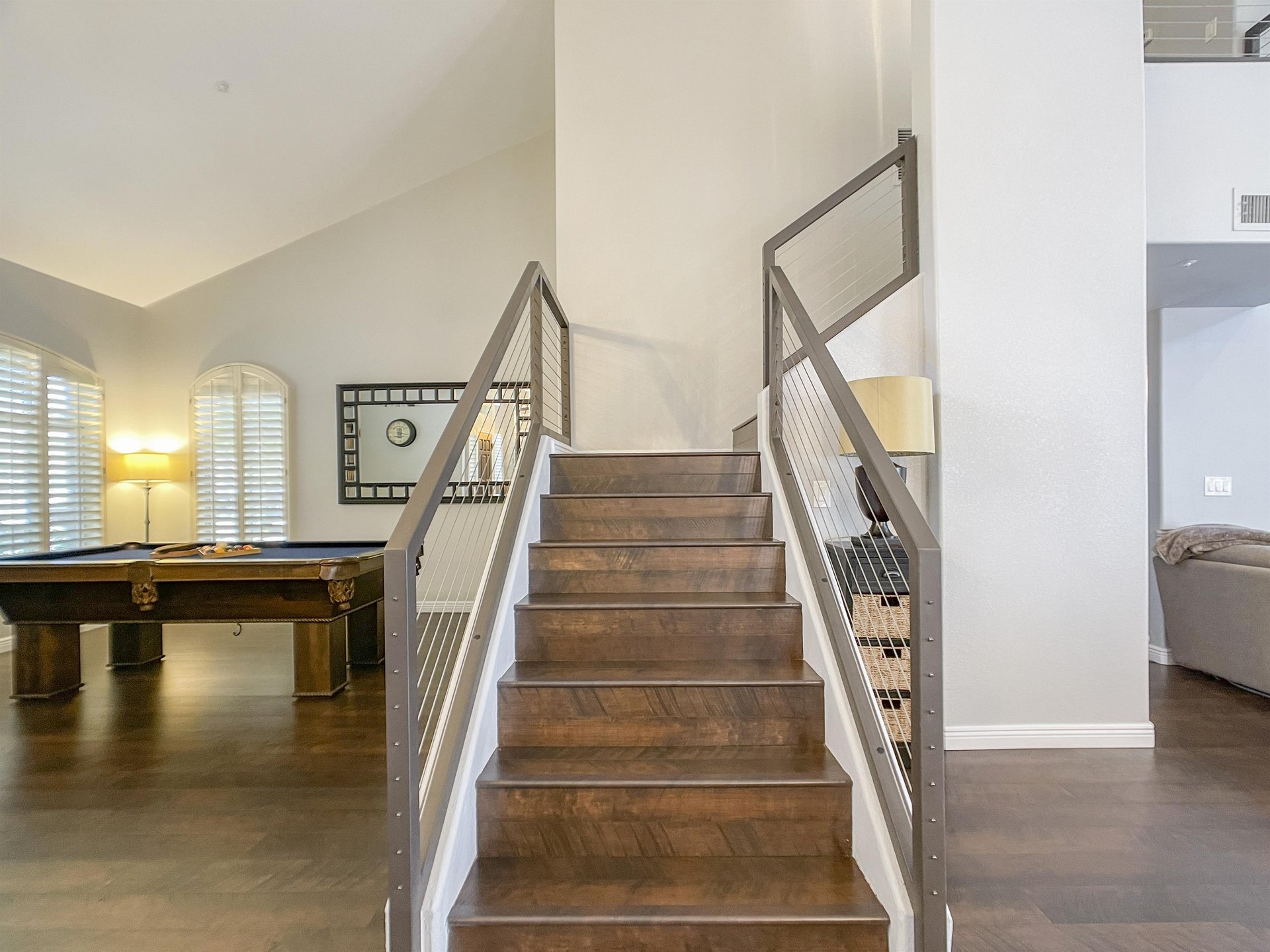 The sleek and slightly industrial stairwell heading toward second floor