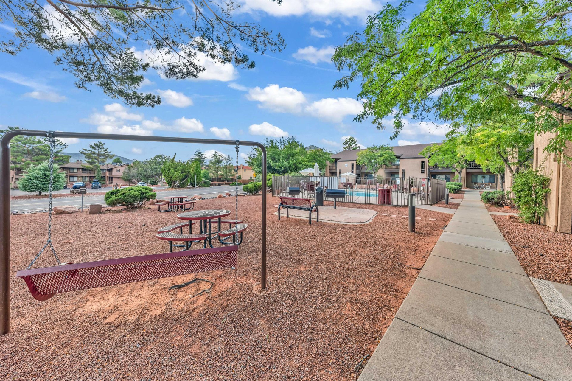 Recreational Area With BBQ, Swing, And Seating Area