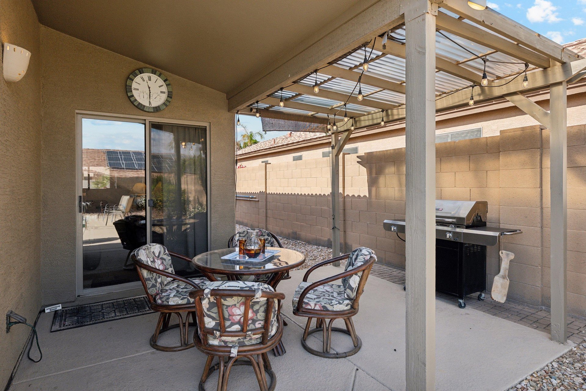 Covered Patio Space with Rattan Dining Set and BBQ for evening cookouts