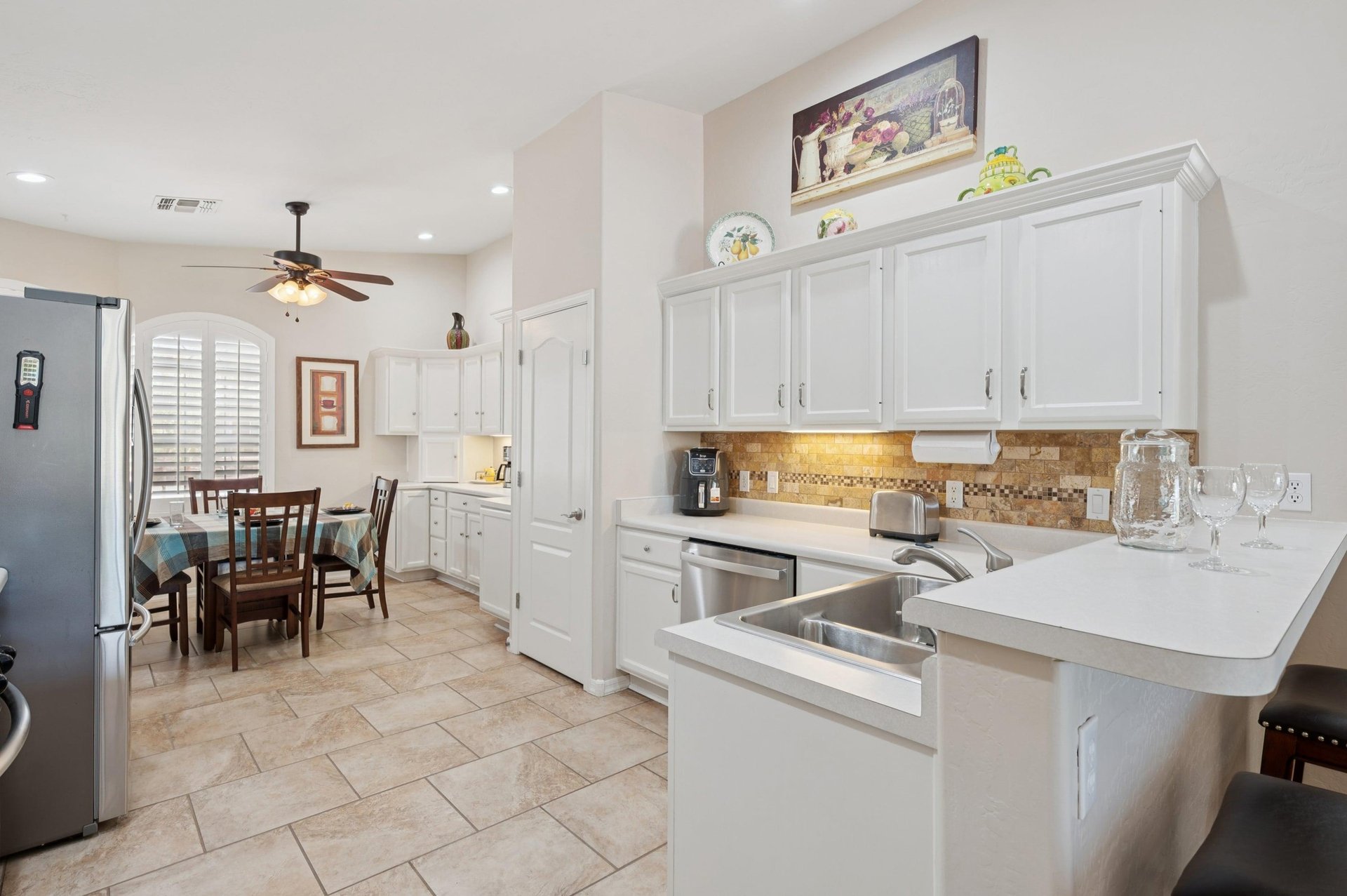 Bright and beautifully decorated featuring sleek white finishes and undercabinet lighting for a modern touch