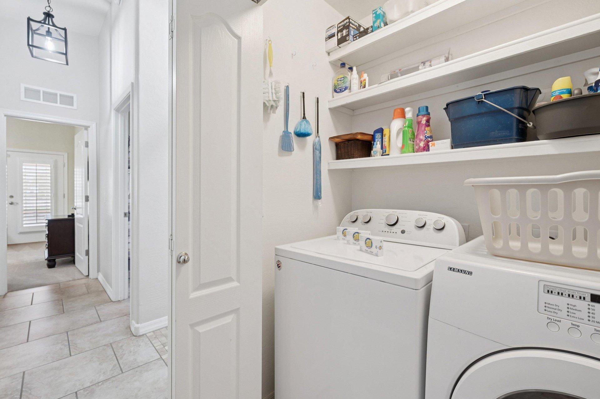 Convenient inhome Washer and Dryer stocked with some cleaning supplies