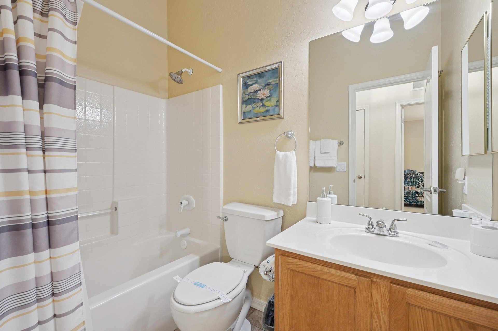 Full bathroom with clean tubshower combo which offers both comfort and convenience