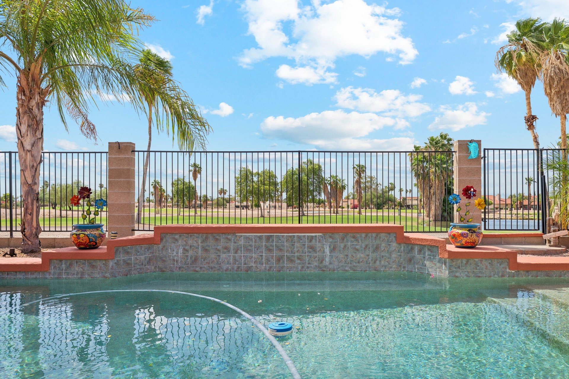 Sparkling pool with open views overlooking the golf course