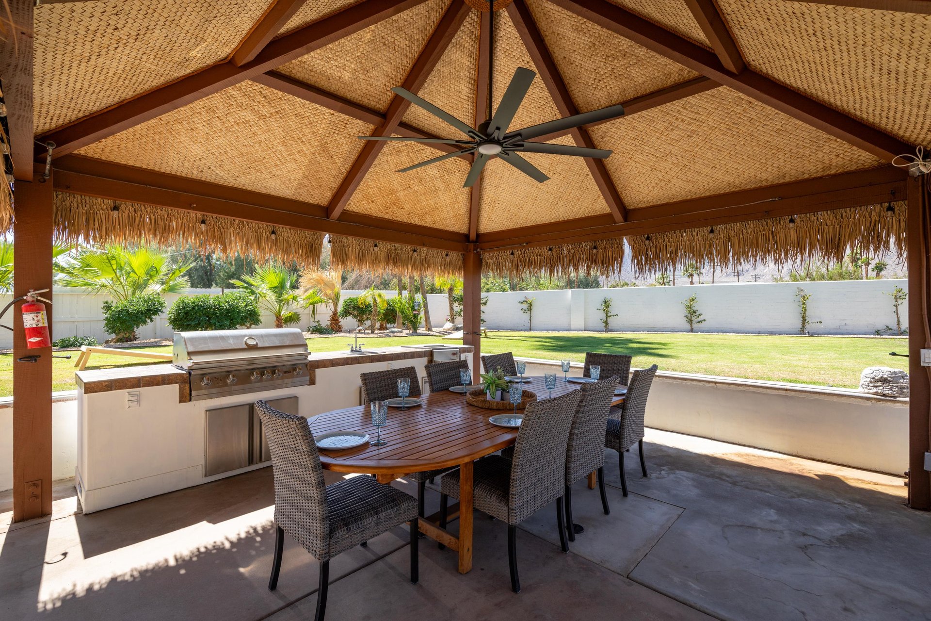 Outdoor kitchen with sink and covered al fresco dining