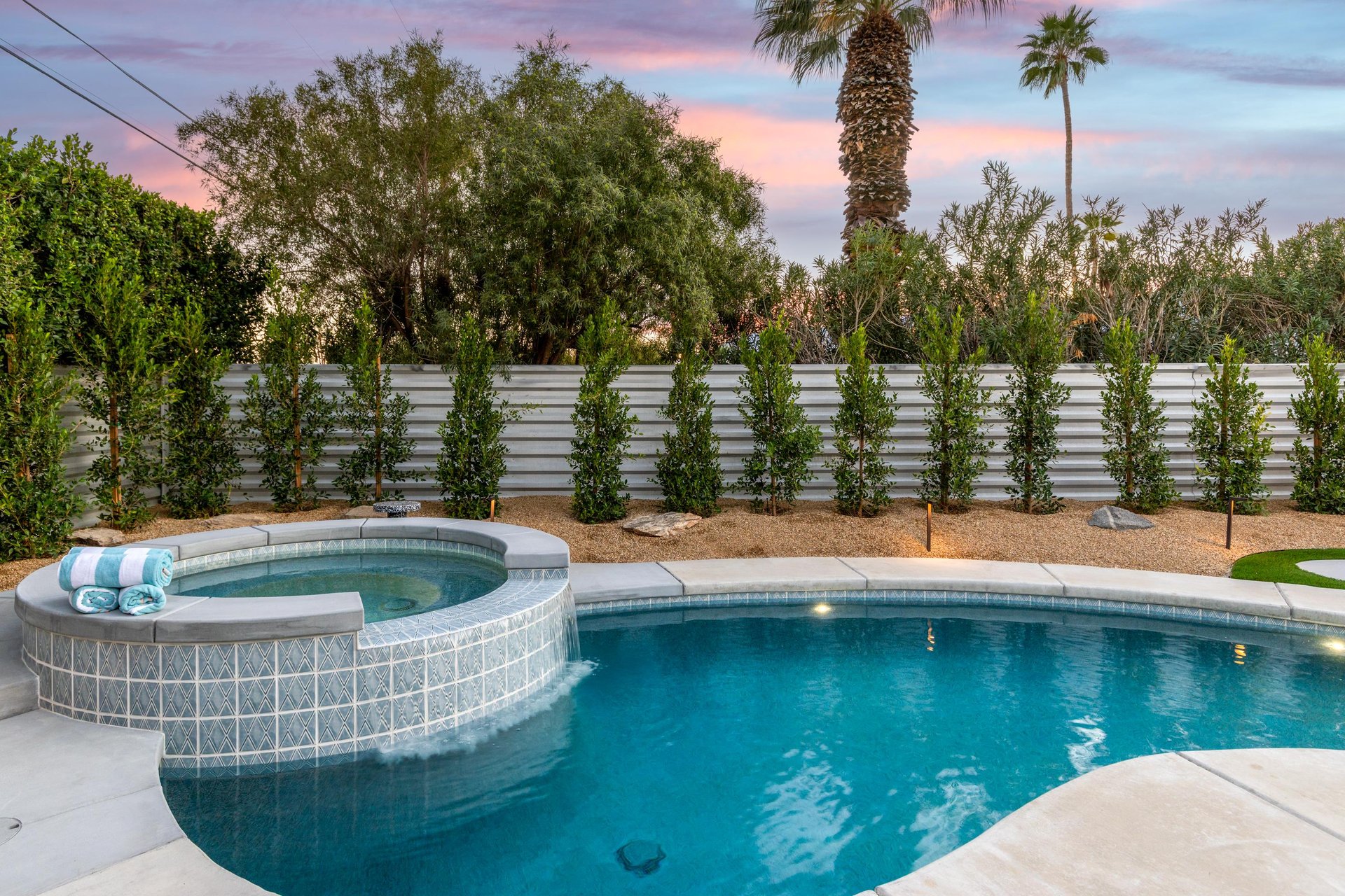 Integrated spa and pool with waterfall feature