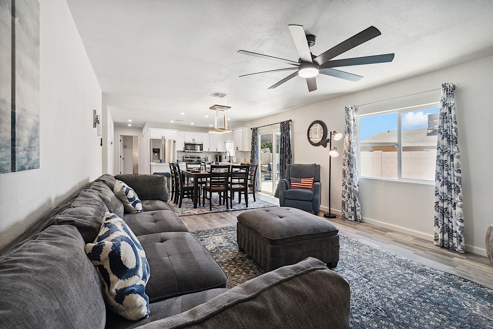 Living room has large sectional sofa, ottoman and reclining chair