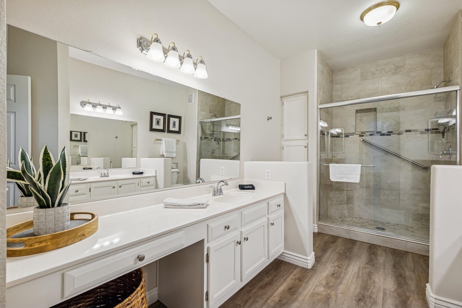 Primary bathroom with walk in shower and dual sinks.