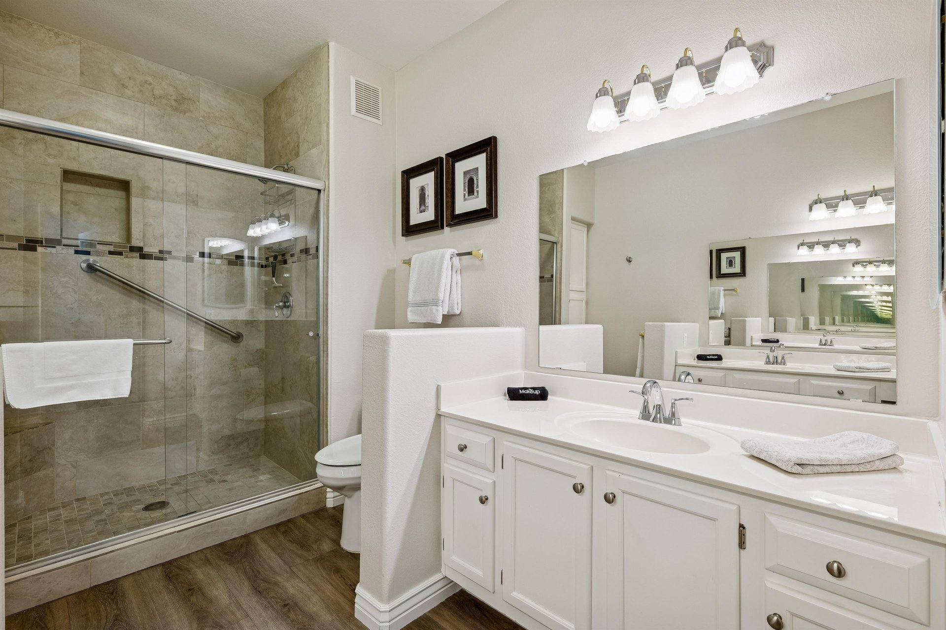 Primary bathroom with walk in shower and dual sinks.