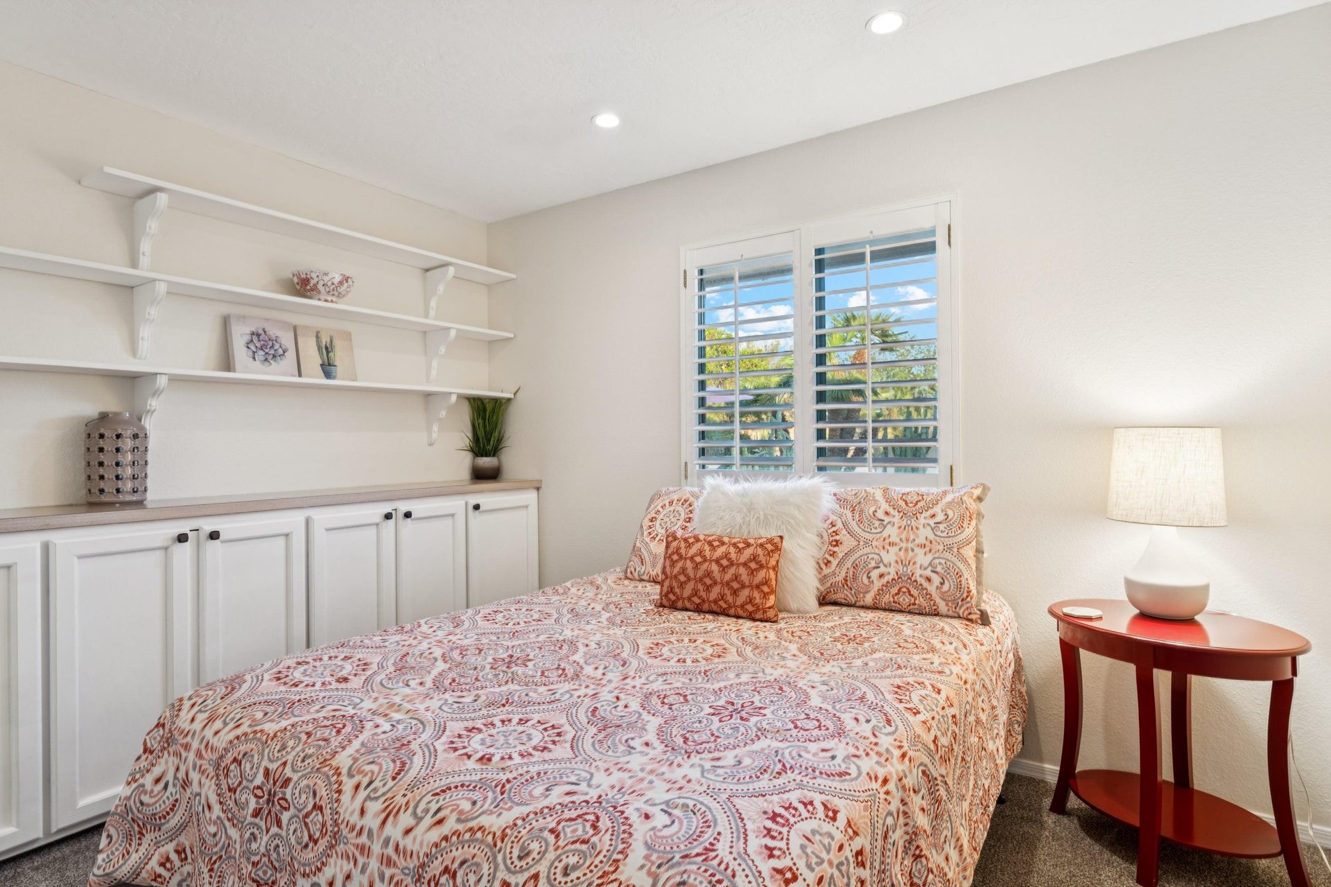 The cozy second bedroom has a calming ambiance with a desk built into the closet Perfect for those working from home