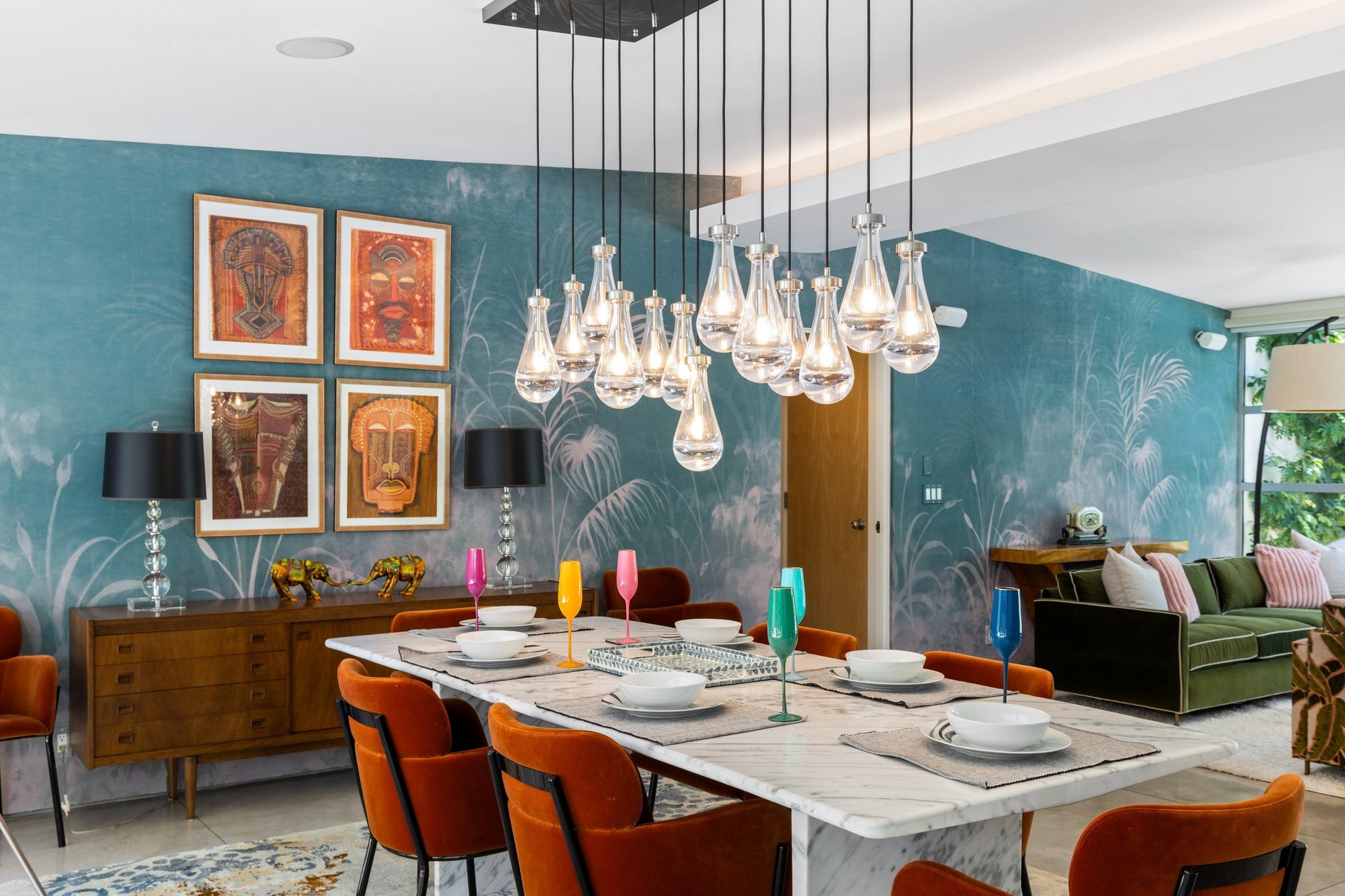 Dine at a marble table set for 6 under a beautiful chandelier.