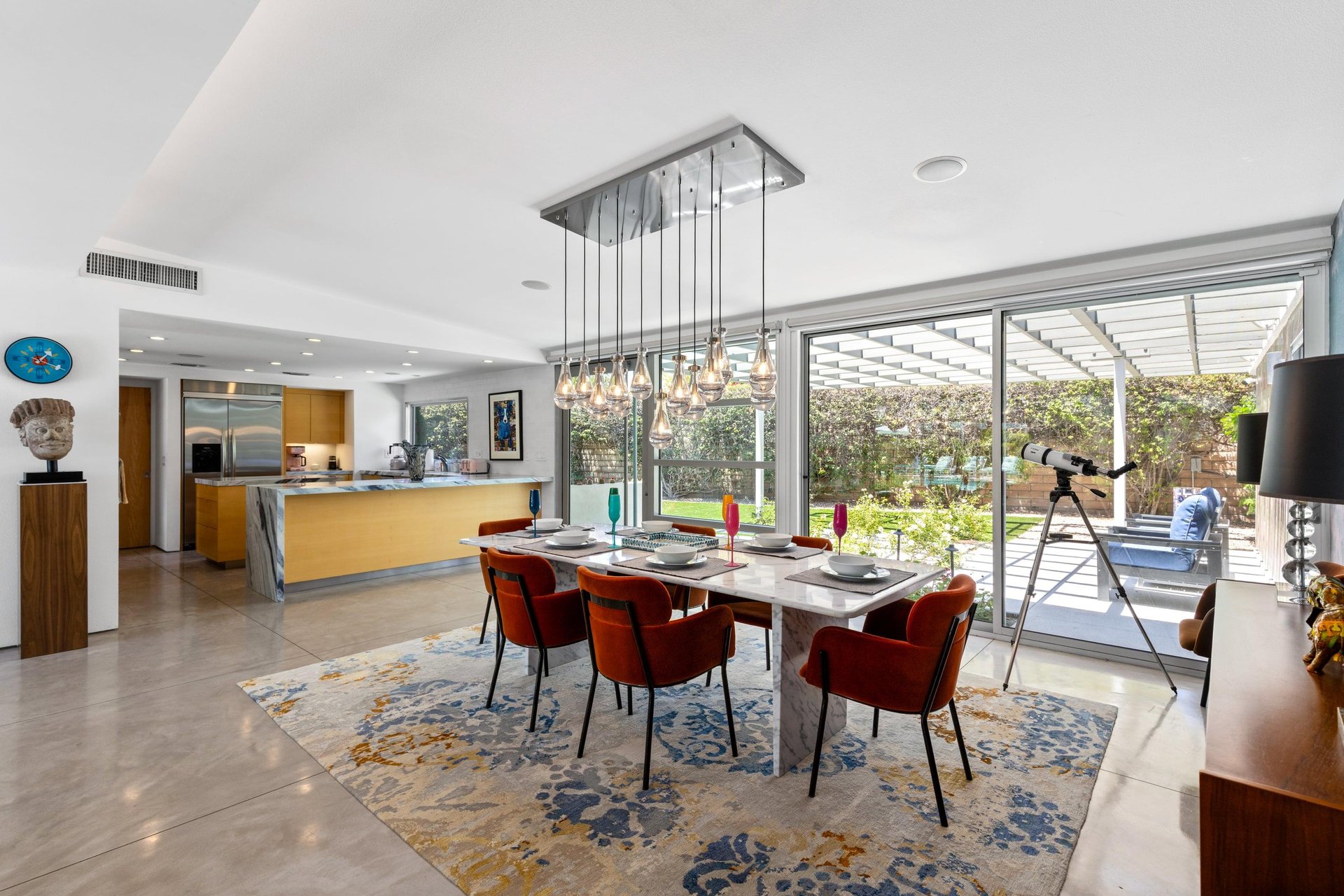 Patio seating can be found through additional sliding glass doors. Kitchen area can also be seen directly from the dining area.