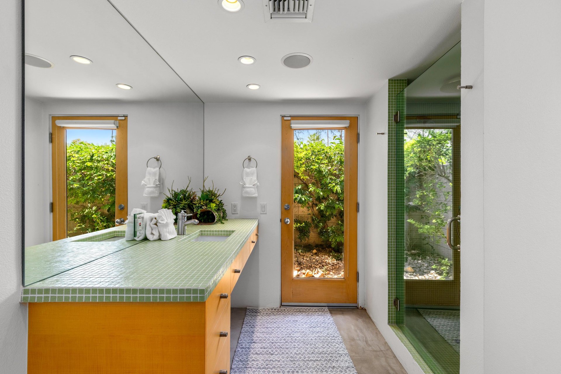 Ensuite bathroom with incredible tile, standalone shower, and door to the outside.