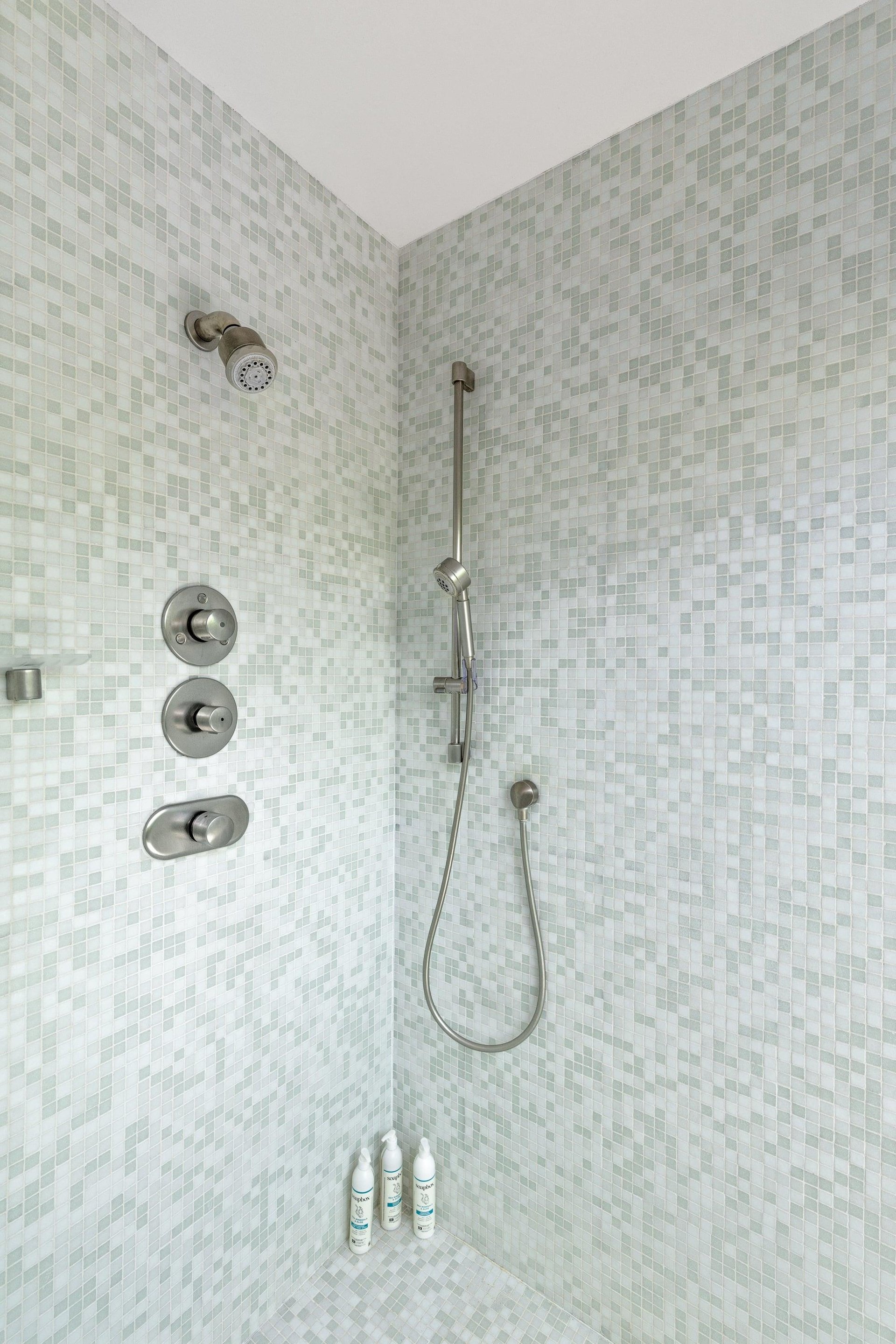 Standalone shower with its own sliding door to turn it into an indooroutdoor shower.