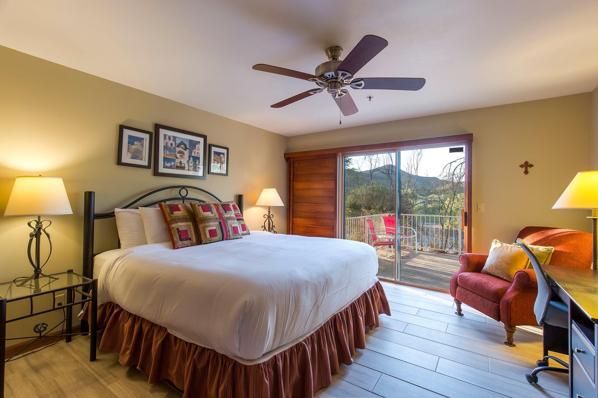 King size bed, desk, ceiling fan, and direct patio access.