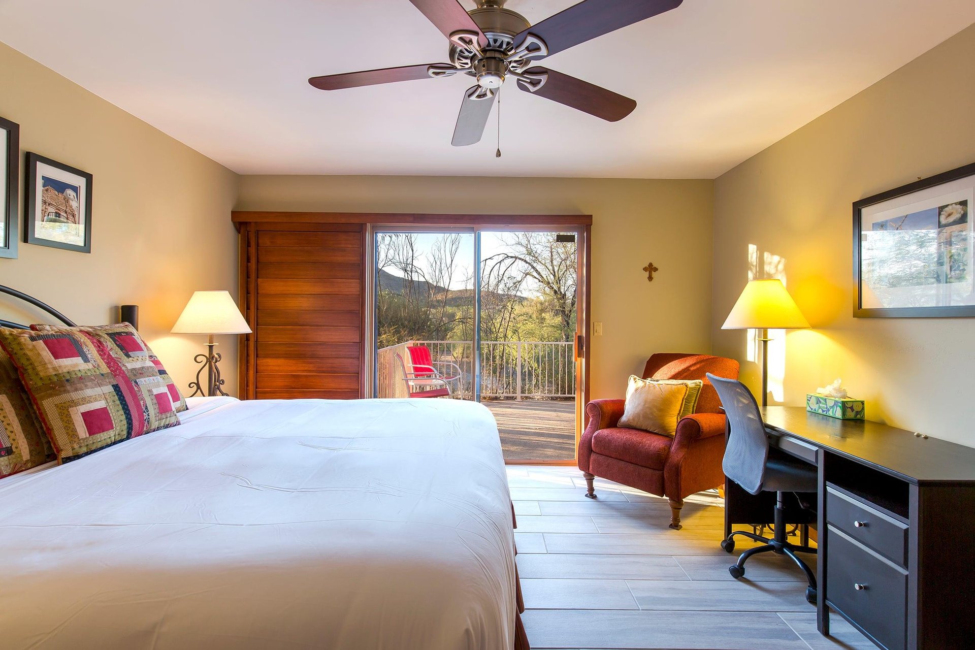 King size bed, desk, ceiling fan, and direct patio access.