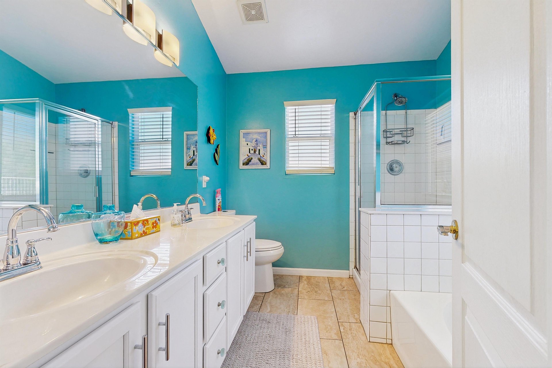 Ensuite bathroom features a stand alone tub, stand alone shower, dual vanity sinks, and counter space.