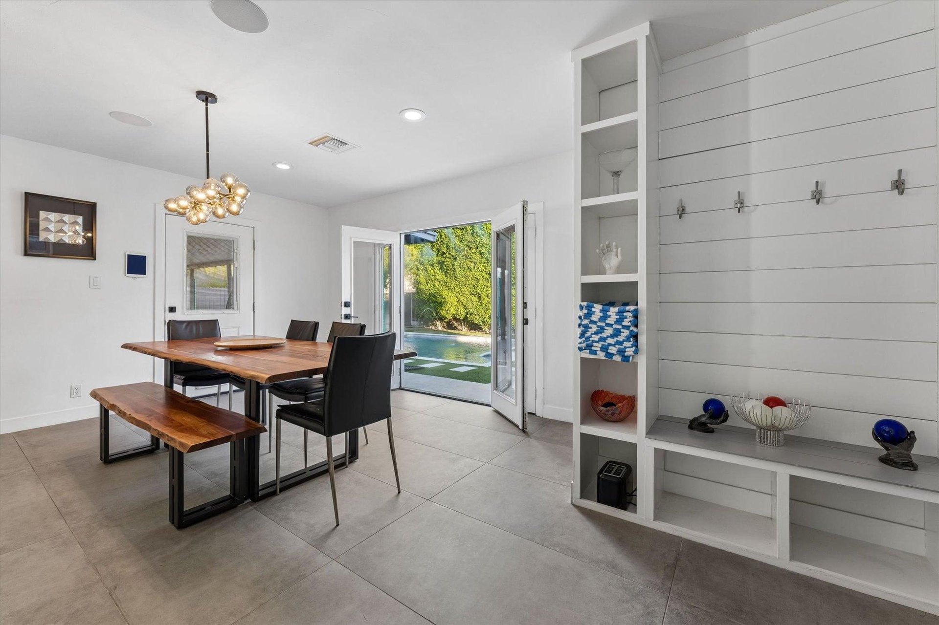 Dining area with table, bench seating, and chairs for up to 6 guests just off of the kitchen.