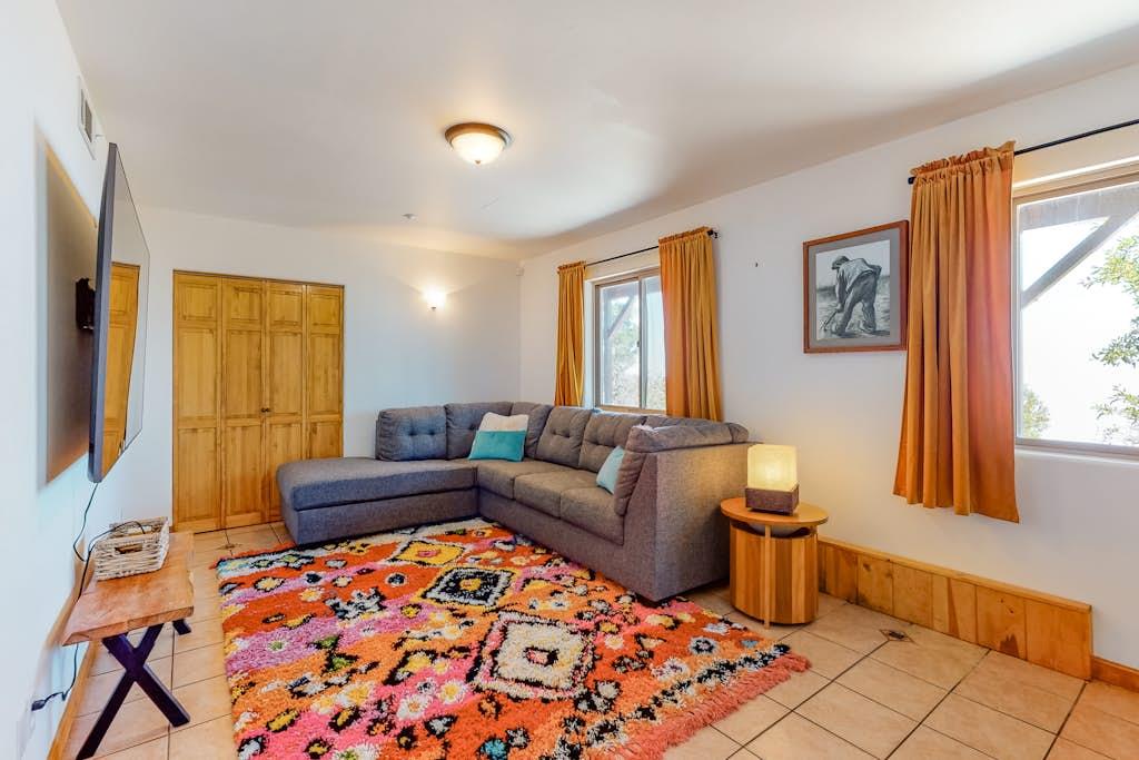 Featuring large sectional sofa, smart TV and black out curtains make a perfect movie night.