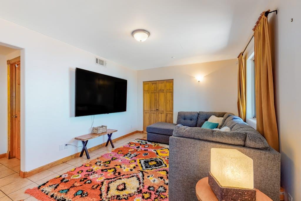 Featuring large sectional sofa, smart TV and black out curtains make a perfect movie night.