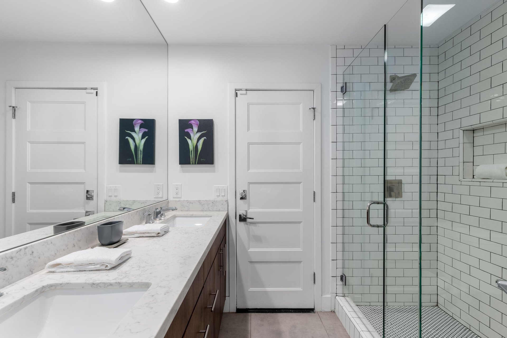 Features a dual vanity sink and walkin shower.