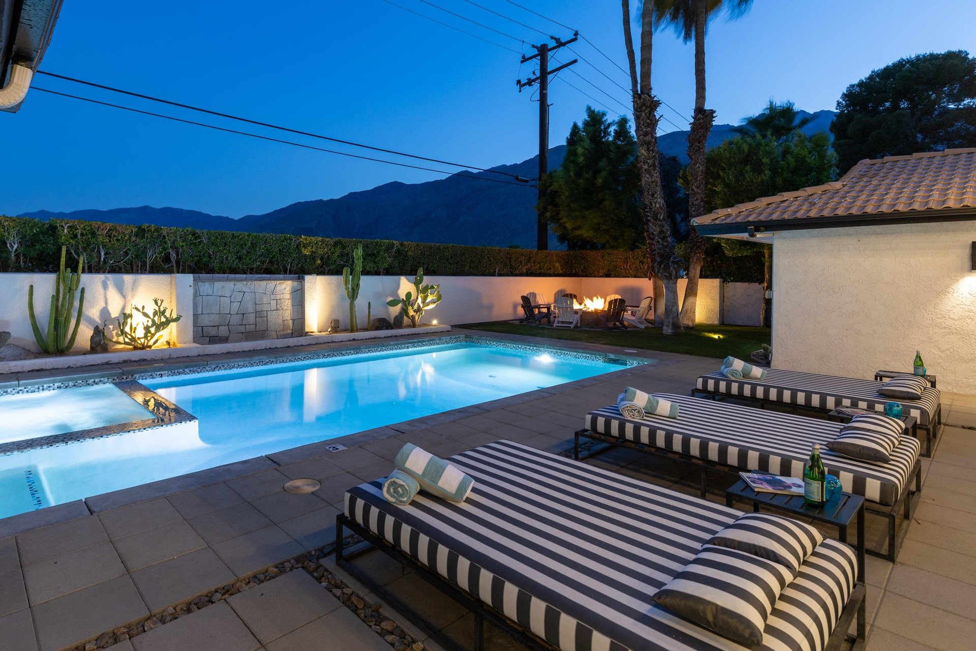 View from patio showing pool, spa, and firepit.