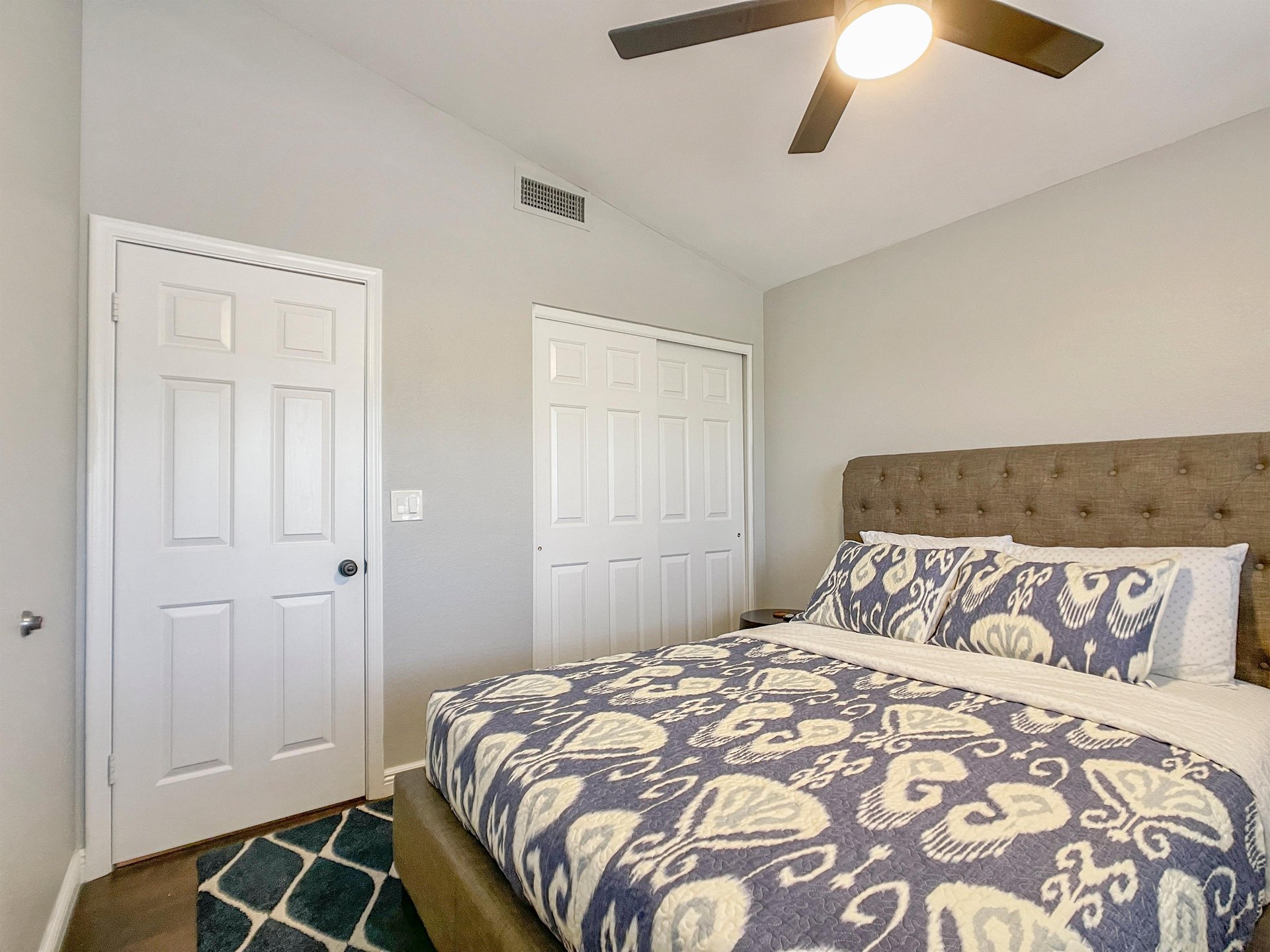 Queen bed in the one of three bedrooms in the home