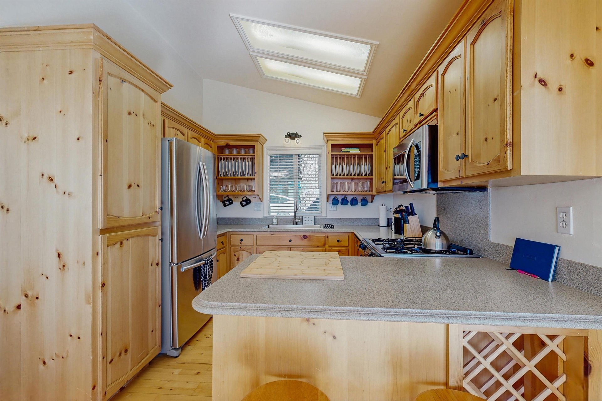 Stainless steel appliances, counter seating for 2, and kitchen essentials.