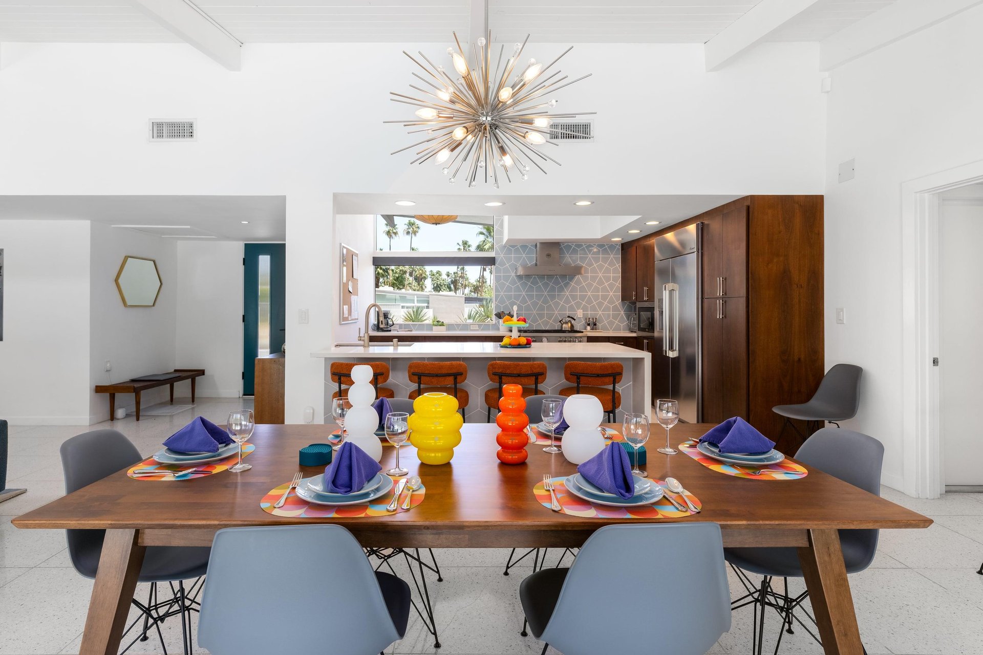 Table and seating for 6 guests, plus additional seating at the island.