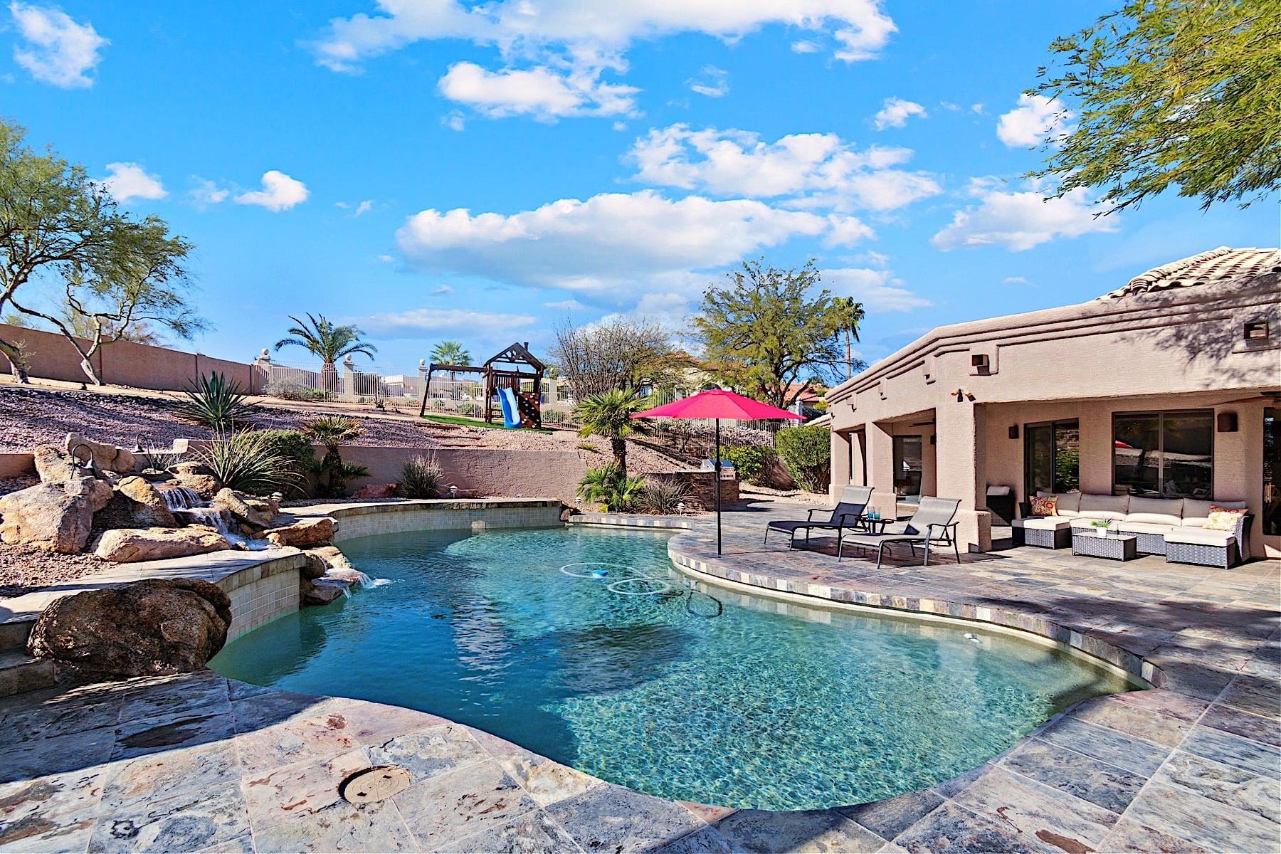 Big backyard with heated pool 140 nightly cost, sun loungers, outdoor kitchen, and mountain views