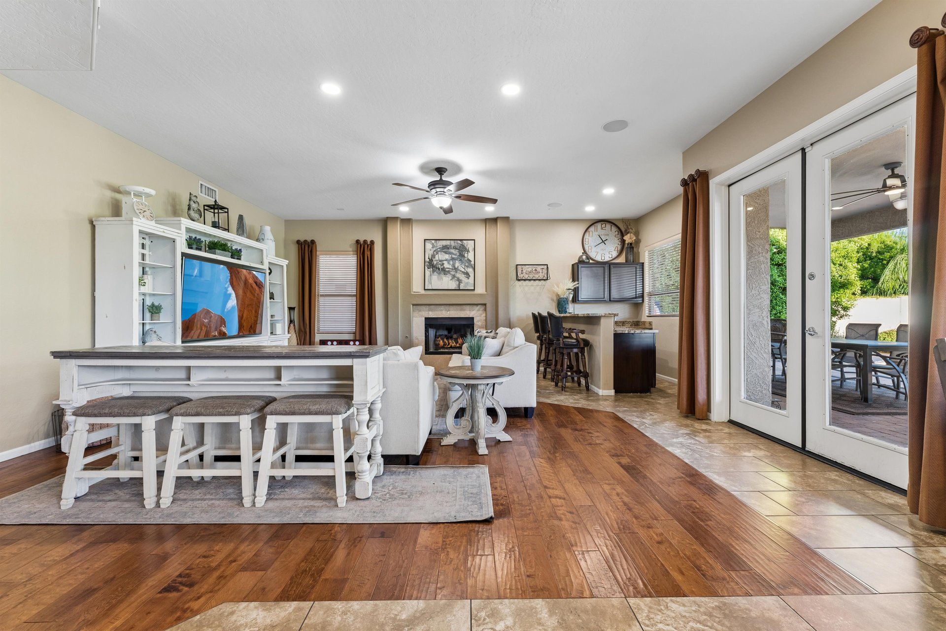 Living room features plenty of seating, additional sleeping space with pullout sofa beds, flatscreen TV with streaming, fireplace, and patio access.