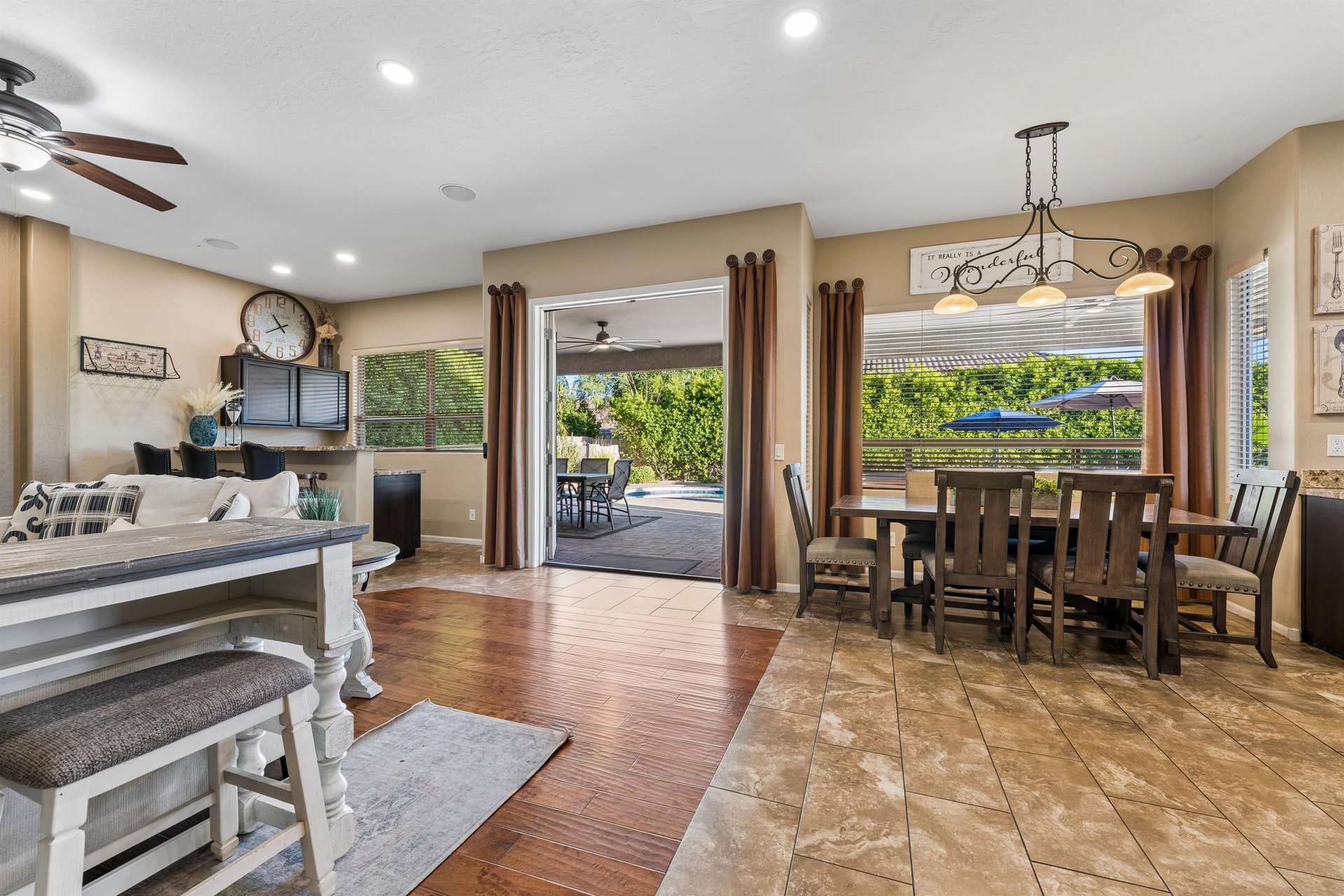 Dining area with a table and seating for can be seen just off of the living room and kitchen.