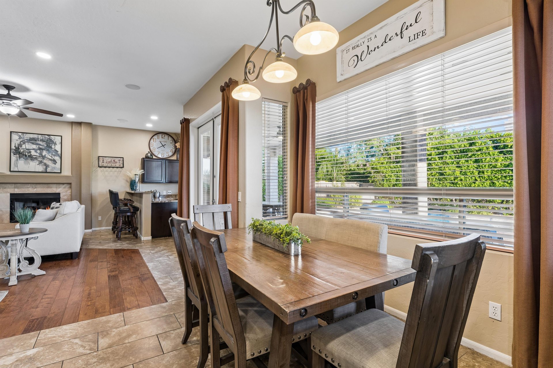 Dining area with a table and seating for can be seen just off of the living room and kitchen.