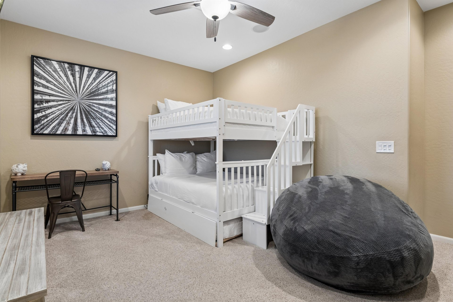 Full over full bunk bed, twin trundle bed, flatscreen TV, beanbag, and desk space.