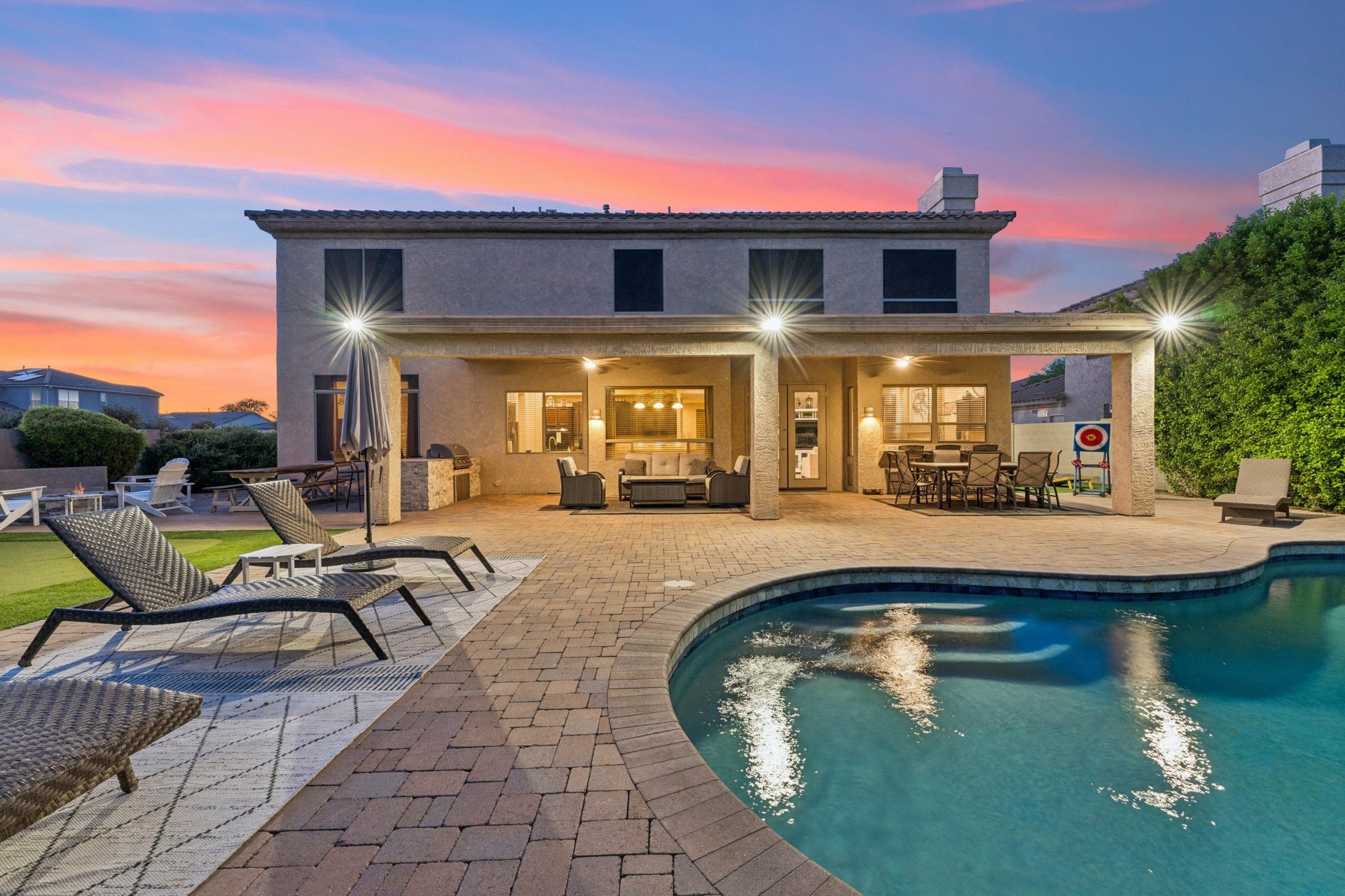 Private pool, putting green, patio seating, BBQ, firepit, and outdoor games.