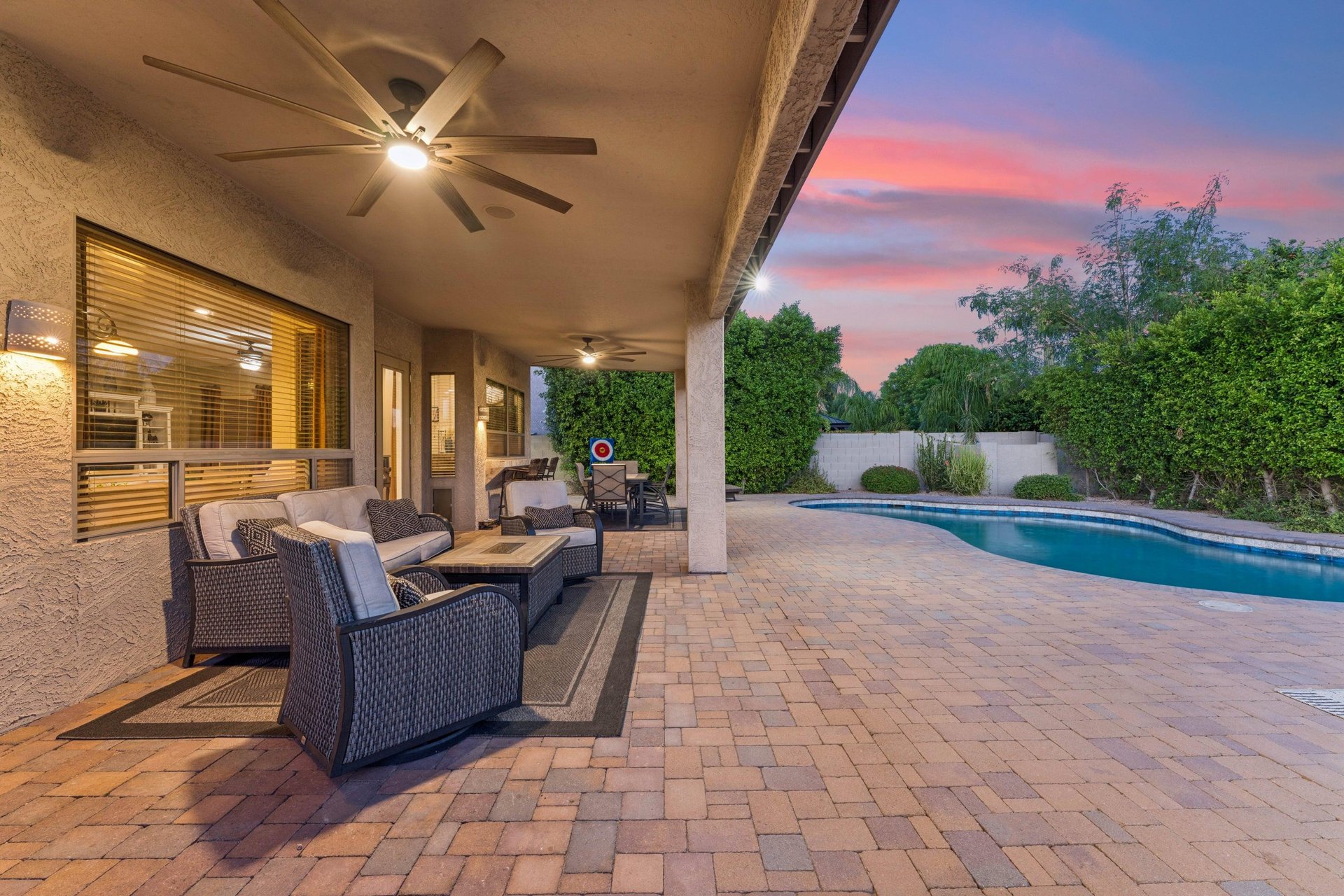 Plenty of outdoor seating on the patio overlooking the pool area, with outdoor ceiling fans.