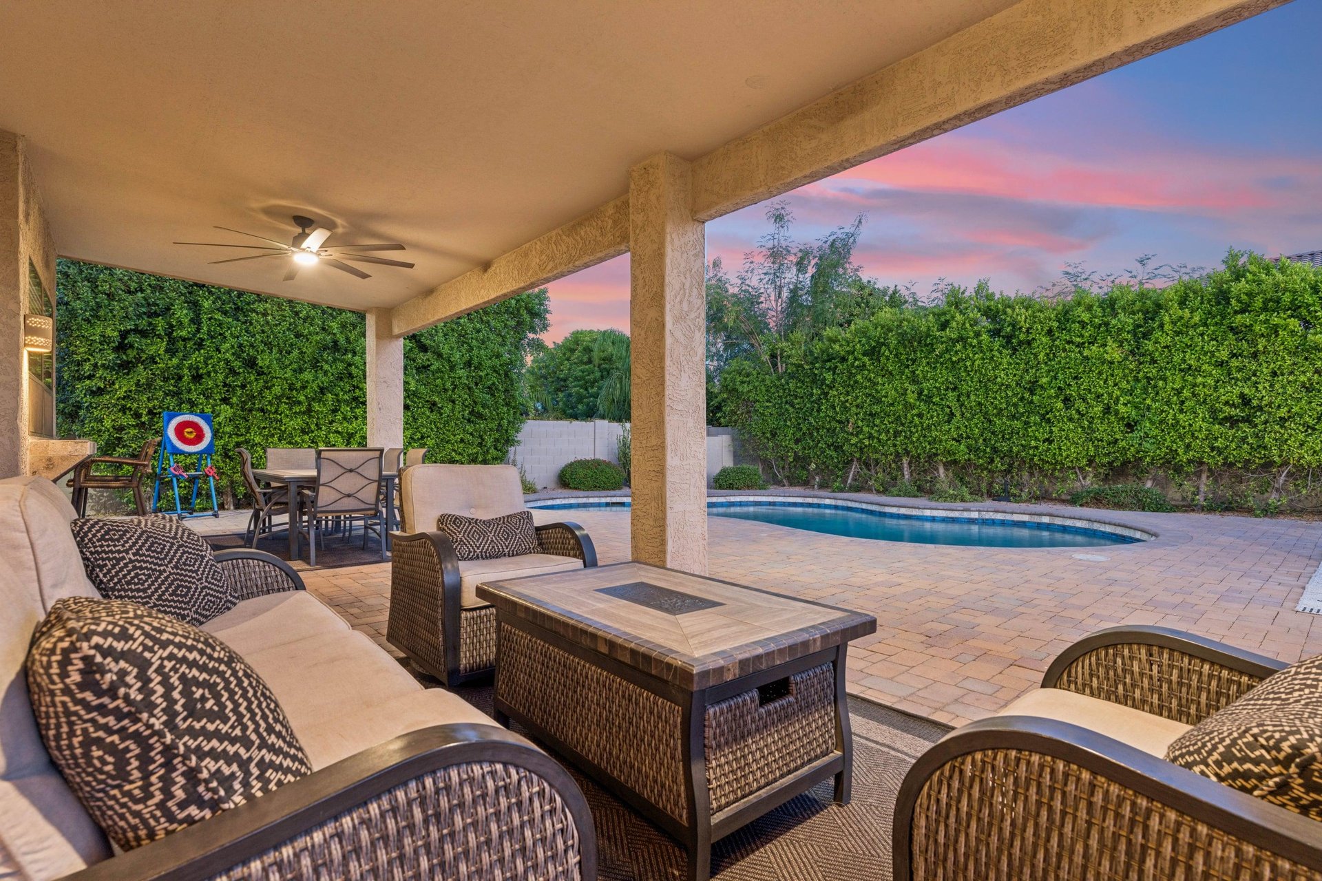 Plenty of outdoor seating on the patio overlooking the pool area, with outdoor ceiling fans.