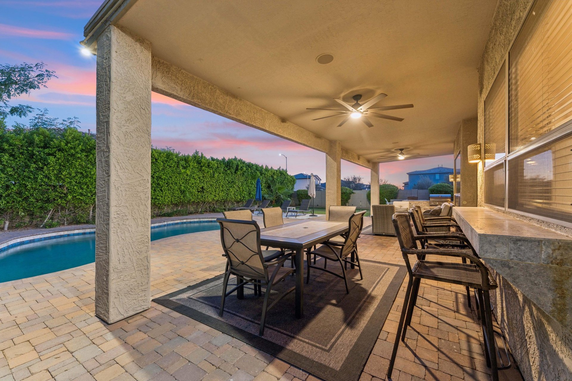 Plenty of outdoor seating on the patio overlooking the pool area, with outdoor ceiling fans.