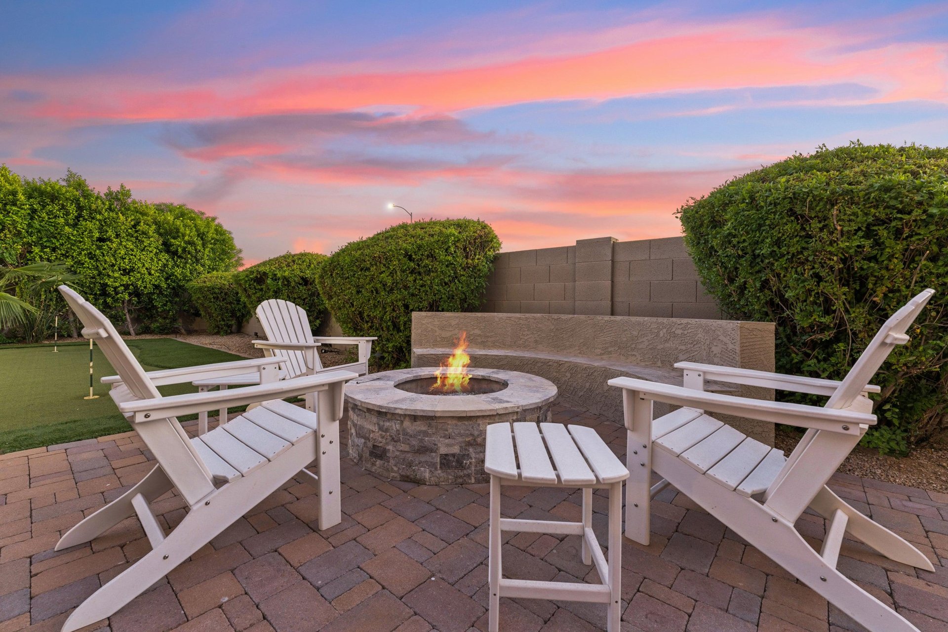 Firepit with plenty of built in seating and additional chairs.