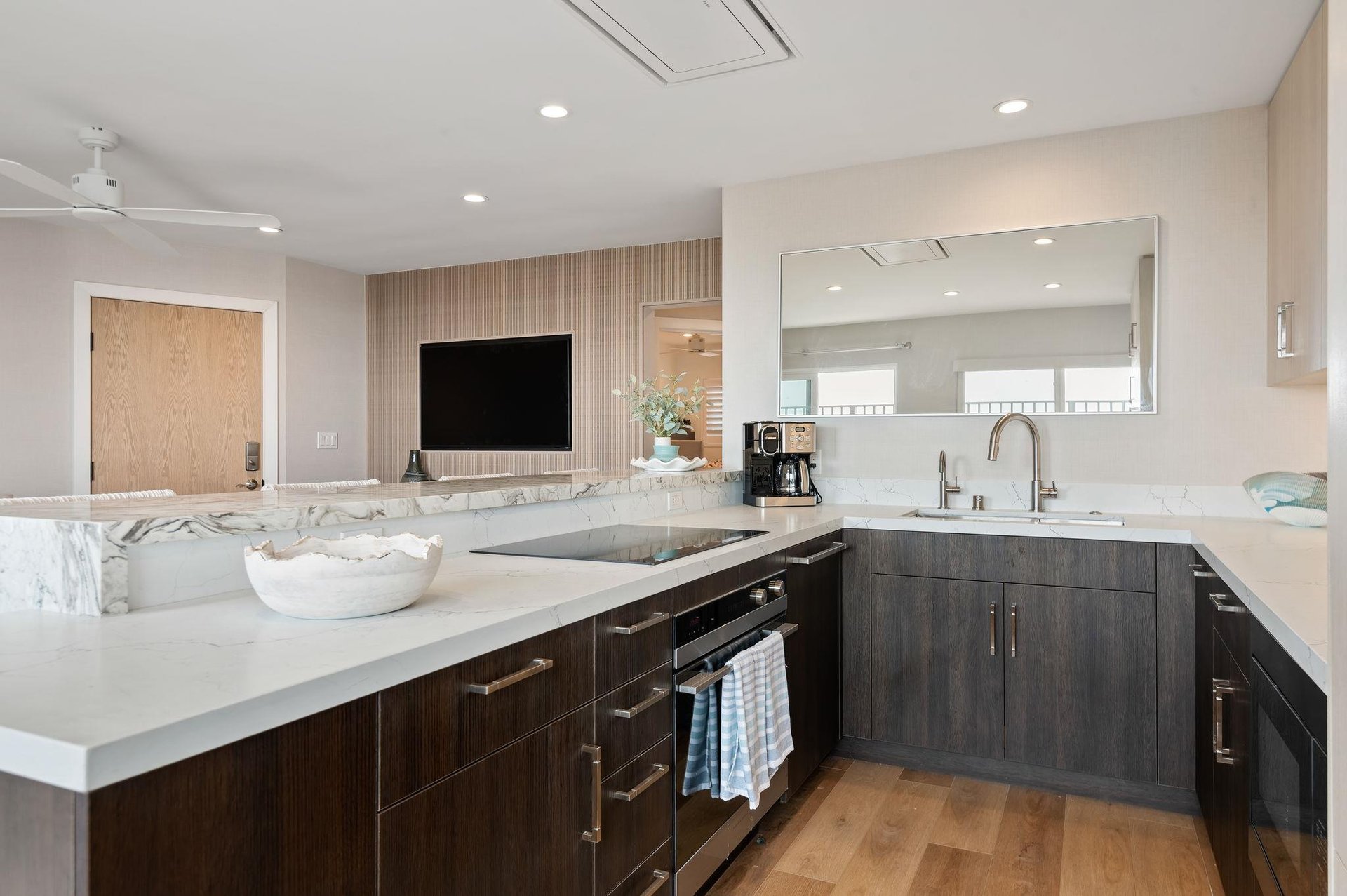 Kitchen view with all appliances and living room view.